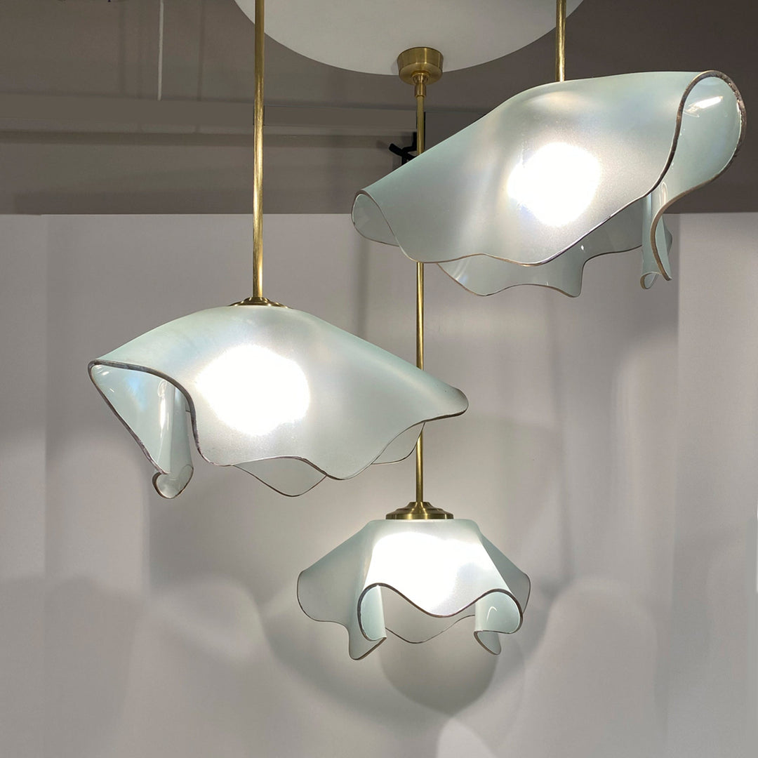 Anemone shaped triple chandeliers made from frosted glass with a 24k gold trim.