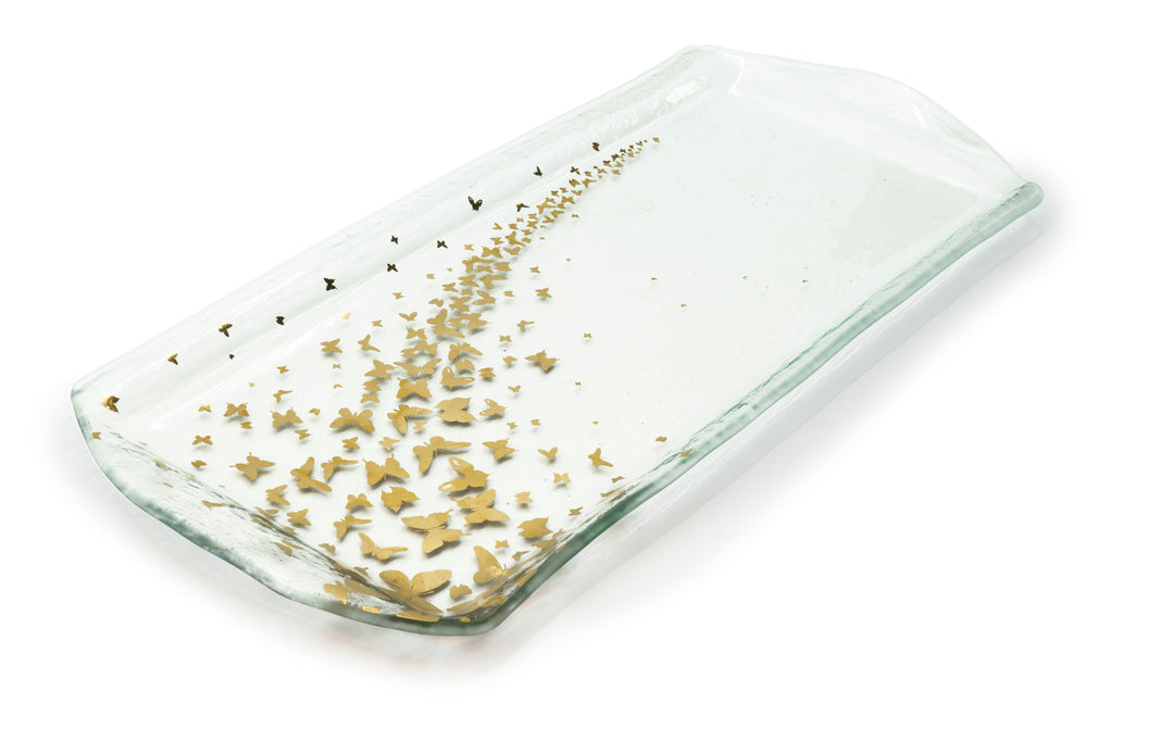 Clear rectangular tray on clear glass with butterflies coming up from the bottom to one side.