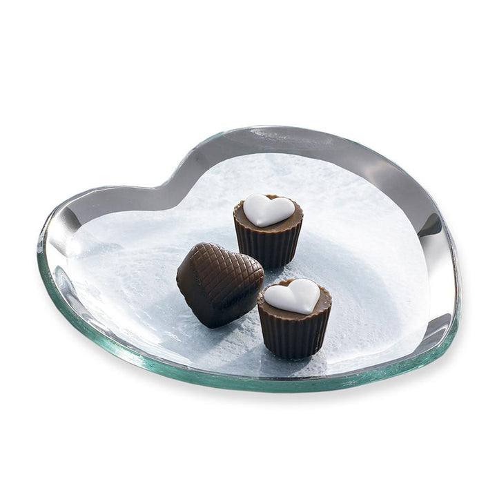 Roman antique 7" clear heart shaped plate with a platinum band and three chocolates.