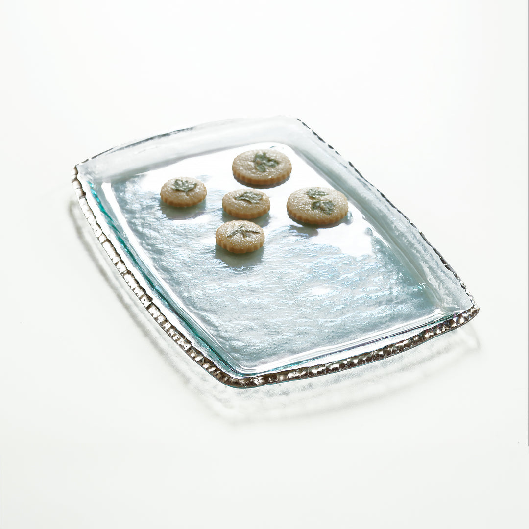 Edgey clear tray with a platinum edge and cookies on top.