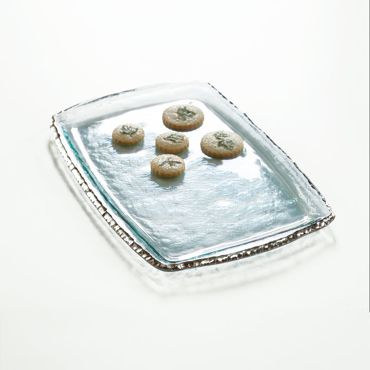 Edgey clear tray with a platinum edge and cookies on top.