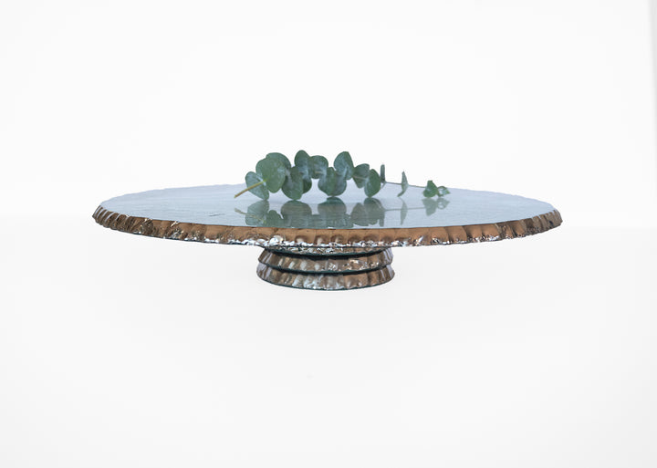 Edgey cake plate with a platinum rim and base with a eucalyptus on top.