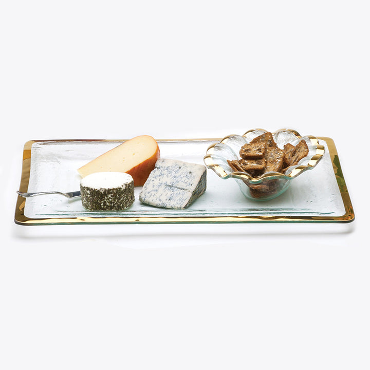 Long buffet server with cheeses and a ruffle dip bowl with crackers.