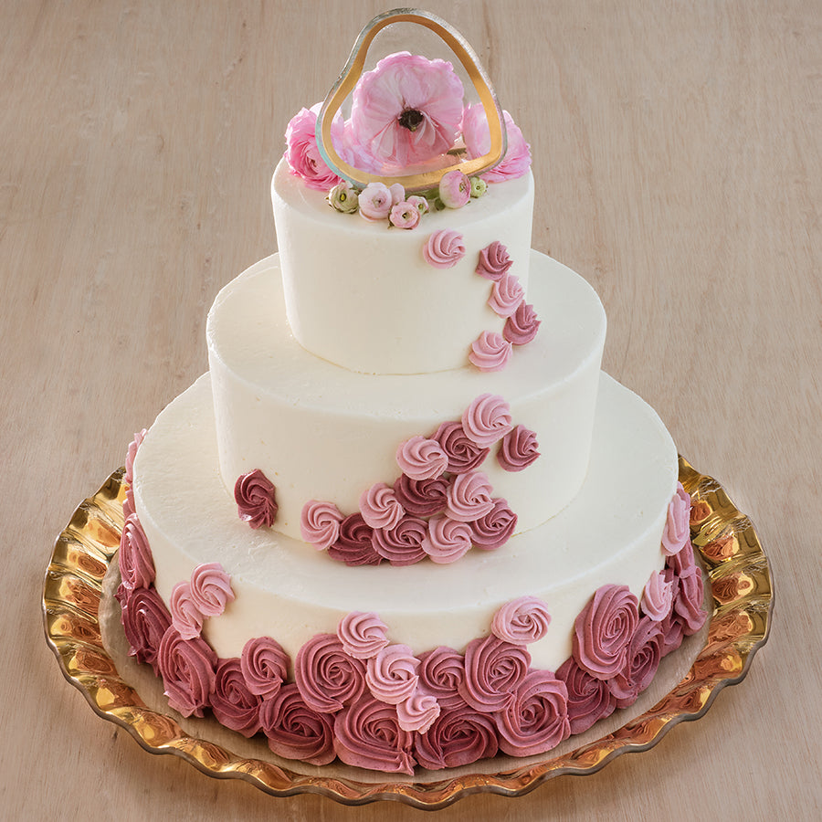 Handmade giant round platter with a 24k gold band and a 3 layer cake with a small heart shaped bowl as a topper.