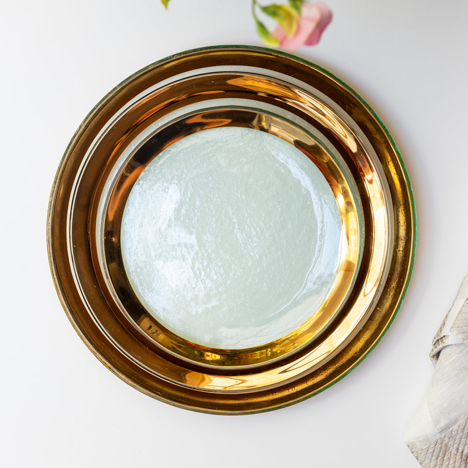 Annieglass Roman Antique dinnerware with 24 gold rim.