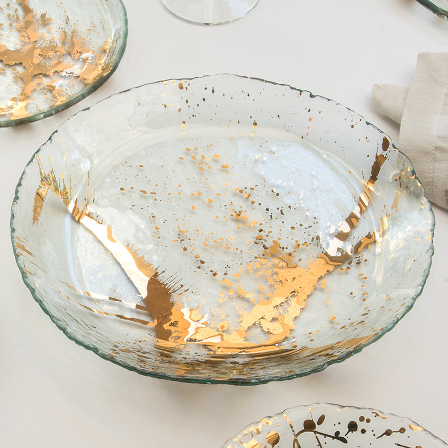 Jaxson serving bowl with a chipped edge and a 24k gold splatter design.