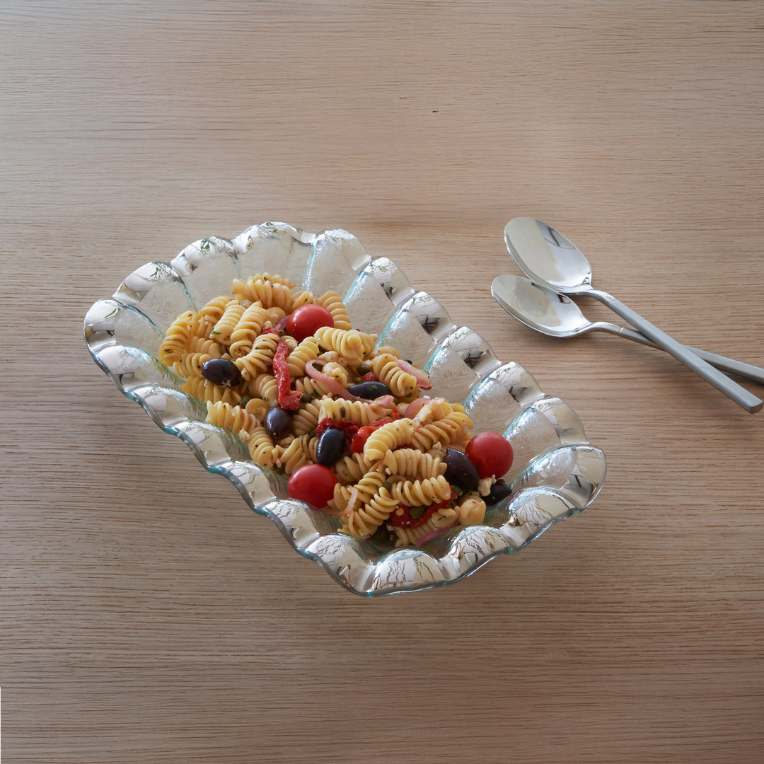 Ruffle rectangular bowl with a platinum band and pasta with serving spoons.