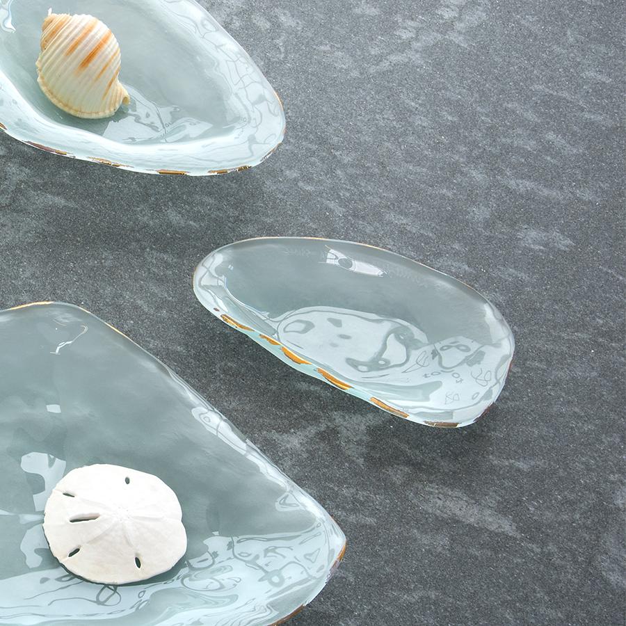 Frosted glass coquina table decor with a 24k gold trim on the edge.