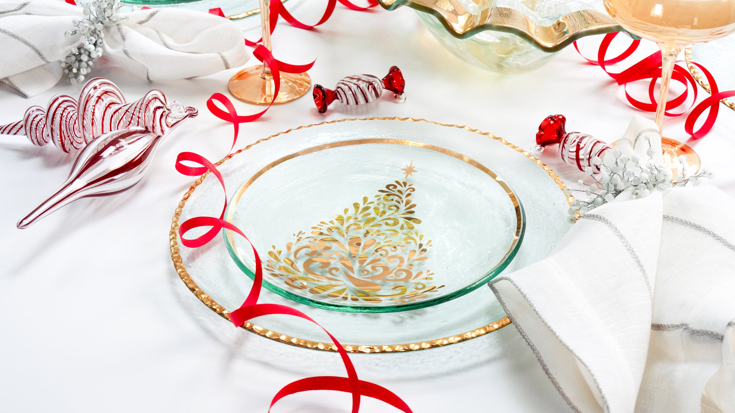 Christmas table setting using 2022 Christmas dinner plate and an Edgey charger. The table is decorated with candy cane ornaments