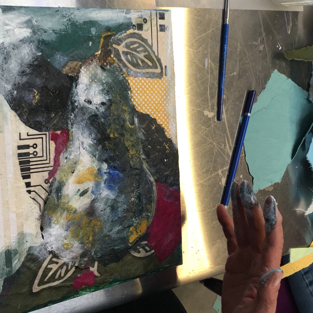 Artistic process with paintbrush, palette, and partially completed artwork.