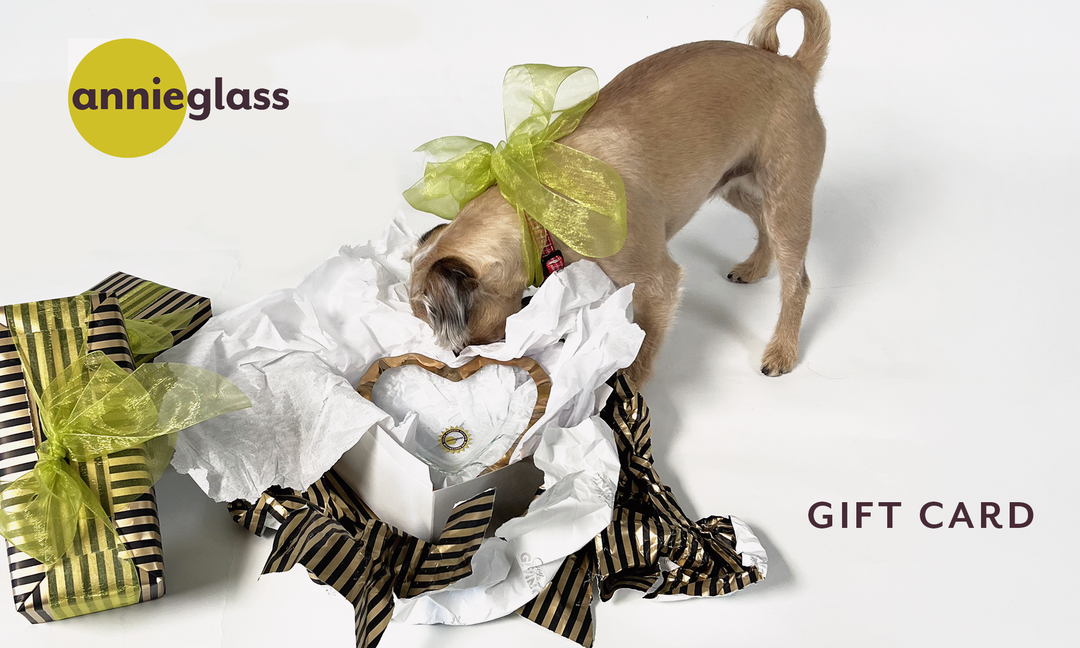 Gift Card image showing a dog searching through open box with scattered gift wrap