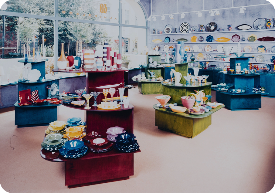 First Annieglass storefront. Display of colorful ceramic and glass items in a store setting.
