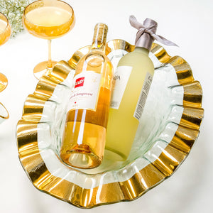Ruffle wine cooler with 2 bottles of wine with two champagne glasses in the background